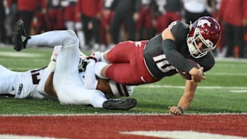 Sep 7, 2024; Pullman, Washington, USA; Washington State Cougars quarterback John Mateer (10) stretches for a touchdown against Texas Tech Red Raiders defensive back A.J. McCarty (1) in the first half at Gesa Field at Martin Stadium. Mandatory Credit: James Snook-Imagn Images