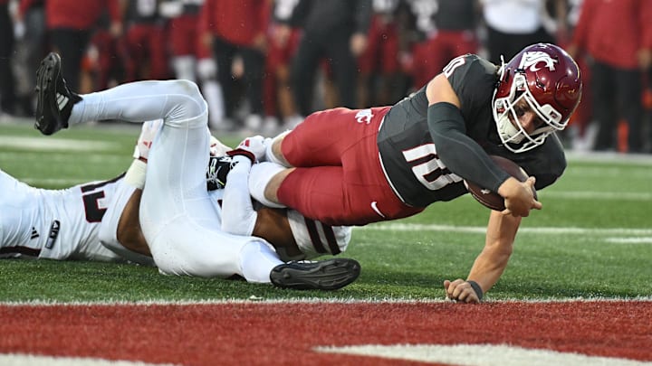 Sep 7, 2024; Pullman, Washington, USA; Washington State Cougars quarterback John Mateer (10) stretches for a touchdown against Texas Tech Red Raiders defensive back A.J. McCarty (1) in the first half at Gesa Field at Martin Stadium. Mandatory Credit: James Snook-Imagn Images