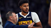 Oct 25, 2025; Denver, Colorado, USA; Denver Nuggets forward Cameron Johnson (23) talks with head coach David Adelman during the first half against the Phoenix Suns at Ball Arena. Mandatory Credit: Christopher Hanewinckel-Imagn Images