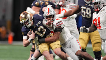Jan 20, 2025; Atlanta, GA, USA; Notre Dame Fighting Irish quarterback Riley Leonard (13) is tackled by Ohio State Buckeyes safety Sonny Styles (6) in the second half in the CFP National Championship college football game at Mercedes-Benz Stadium. Mandatory Credit: Dale Zanine-Imagn Images