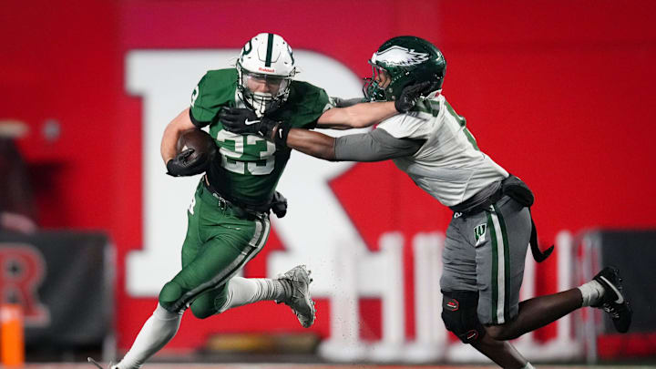 Ramapo senior Liam Hayward (23) runs the ball as Winslow junior Benjamin Carter (8) defends during the Group 4 state football championship game at SHI Stadium, Nov 30, 2025, Piscataway, New Jersey, United States.