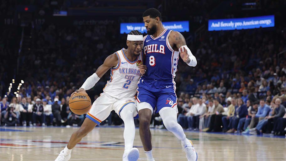 Oklahoma City Thunder guard Shai Gilgeous-Alexander drives down the court against Philadelphia 76ers forward Paul George.