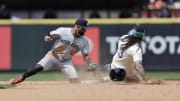Jun 30, 2024; Seattle, Washington, USA; Seattle Mariners shortstop J.P. Crawford (3) steals second before the tag from Minnesota Twins shortstop Willi Castro (50) during the sixth inning at T-Mobile Park.