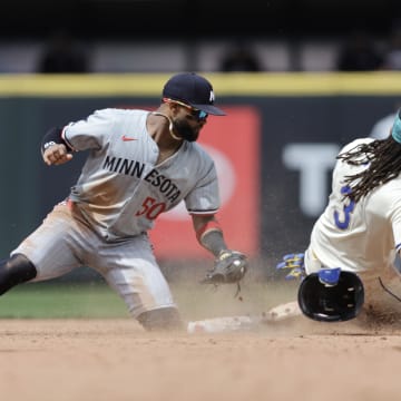 Jun 30, 2024; Seattle, Washington, USA; Seattle Mariners shortstop J.P. Crawford (3) steals second before the tag from Minnesota Twins shortstop Willi Castro (50) during the sixth inning at T-Mobile Park.