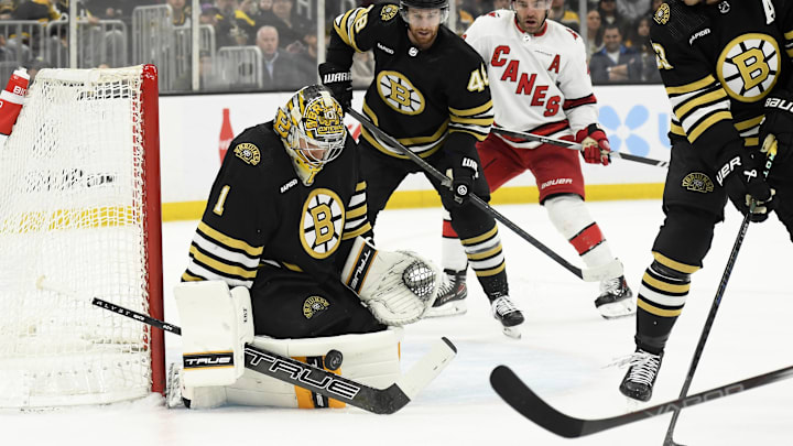 Apr 9, 2024; Boston, Massachusetts, USA; Boston Bruins goaltender Jeremy Swayman (1) makes a save in front of Boston Bruins defenseman while Boston Bruins defenseman Charlie McAvoy (73) looks on during the second period against the Carolina Hurricanes at TD Garden. Mandatory Credit: Bob DeChiara-Imagn Images
