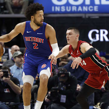 Dec 16, 2024; Detroit, Michigan, USA;  Detroit Pistons guard Cade Cunningham (2) is defended by Miami Heat guard Tyler Herro (14) in the first half at Little Caesars Arena. Mandatory Credit: Rick Osentoski-Imagn Images