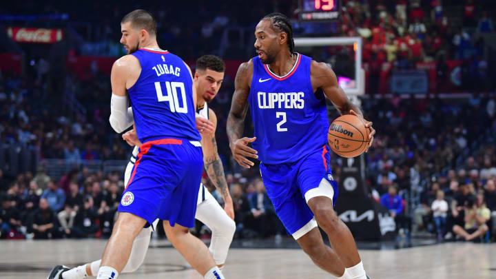  Los Angeles Clippers forward Kawhi Leonard (2) moves the ball as center Ivica Zubac (40) provides coverage against Denver Nuggets forward Michael Porter Jr. (1) during the first half at Crypto.com Arena. 