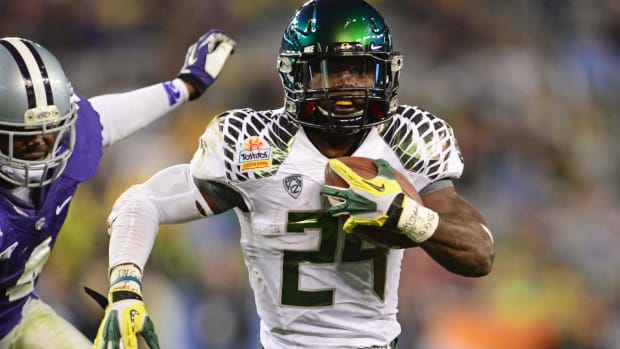 Jan. 3, 2013; Glendale, AZ, USA: Oregon Ducks running back Kenjon Barner (24) rushes the ball in the fourth quarter against t