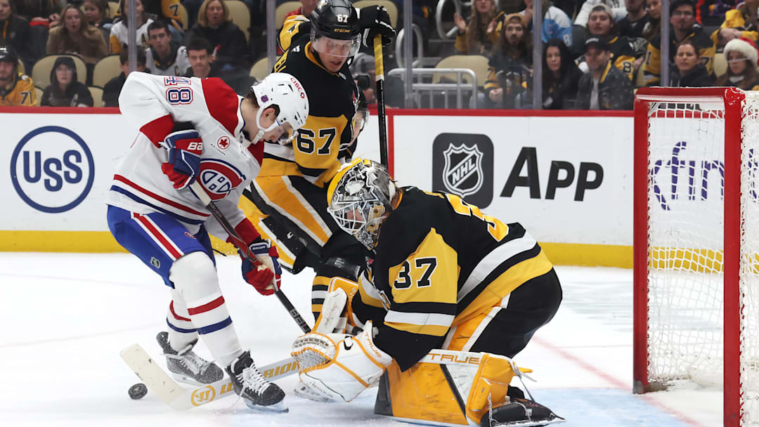 Dec 21, 2025; Pittsburgh, Pennsylvania, USA;  Pittsburgh Penguins goaltender Arturs Silovs (37) makes a save against Montréal Canadiens defenseman Lane Hutson (48) in overtime at PPG Paints Arena. Mandatory Credit: Charles LeClaire-Imagn Images