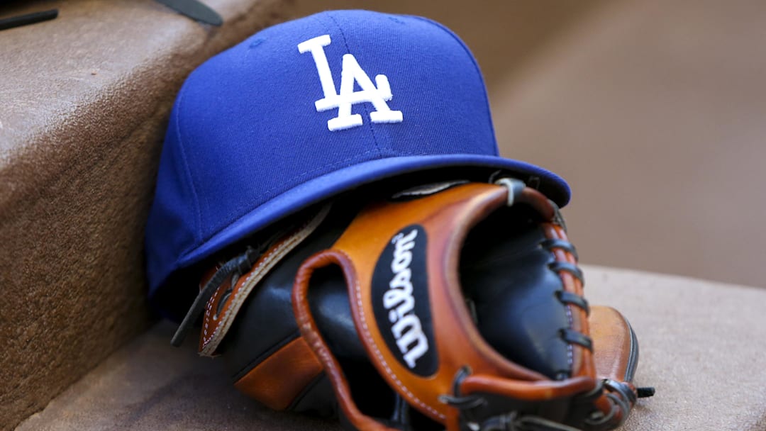Aug 16, 2019; Atlanta, GA, USA; Detailed view of Los Angeles Dodgers hat and glove in the dugout against the Atlanta Braves in the first inning at SunTrust Park. 