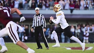 Nov 23, 2024; Starkville, Mississippi, USA; Missouri Tigers quarterback Brady Cook (12) scrambles against the Mississippi State Bulldogs during the second quarter at Davis Wade Stadium at Scott Field. Mandatory Credit: Matt Bush-Imagn Images