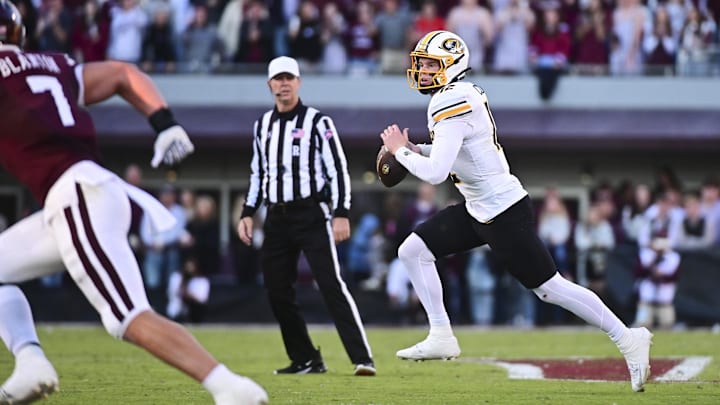 Nov 23, 2024; Starkville, Mississippi, USA; Missouri Tigers quarterback Brady Cook (12) scrambles against the Mississippi State Bulldogs during the second quarter at Davis Wade Stadium at Scott Field. Mandatory Credit: Matt Bush-Imagn Images