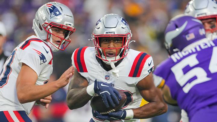 Aug 16, 2025; Minneapolis, Minnesota, USA; New England Patriots running back TreVeyon Henderson (32) runs with the ball against the Minnesota Vikings in the first quarter at U.S. Bank Stadium. Mandatory Credit: Brad Rempel-Imagn Images