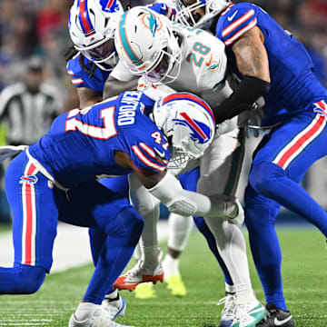 Sep 18, 2025; Orchard Park, New York, USA; Buffalo Bills linebacker Terrel Bernard (8) and cornerback Christian Benford (47) tackle Miami Dolphins running back de'von Achane (28)