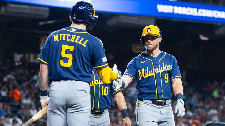 Jul 5, 2026; Phoenix, Arizona, USA; Milwaukee Brewers first baseman Jake Bauers (9) celebrates with teammate Garrett Mitchell after hitting a two run home run in the seventh inning against the Arizona Diamondbacks at Chase Field. Mandatory Credit: Mark J. Rebilas-Imagn Images