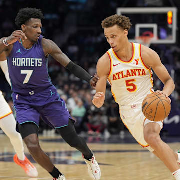Mar 18, 2025; Charlotte, North Carolina, USA; Atlanta Hawks guard Dyson Daniels (5) goes to the basket against Charlotte Hornets guard Damion Baugh (7) during second quarter at Spectrum Center. Mandatory Credit: Jim Dedmon-Imagn Images