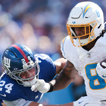 Sep 28, 2025; East Rutherford, New Jersey, USA; Los Angeles Chargers running back Omarion Hampton (8) rushes as New York Giants safety Dane Belton (24) defends during the second quarter at MetLife Stadium. Mandatory Credit: Vincent Carchietta-Imagn Images