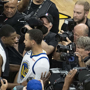 April 30, 2023; Sacramento, California, USA; Golden State Warriors guard Stephen Curry (30) hugs Sacramento Kings guard De'Aaron Fox (5) after game seven of the 2023 NBA playoffs first round at Golden 1 Center. Mandatory Credit: Kyle Terada-Imagn Images