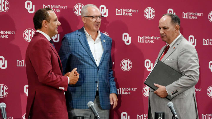 SEC commissioner Greg Sankey, center, talks with OU President Joseph Harroz Jr., left, and OU athletic director Joe Castiglione after a press conference before a celebration for OU joining the Southeastern Conference in Norman, Okla., Monday, July 1, 2024.