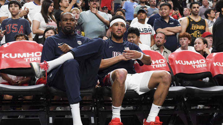 Jul 10, 2024; Las Vegas, Nevada, USA; USA forward Kevin Durant (7) and guard Devin Booker (15) look on from the bench during the fourth quarter against Canada in the USA Basketball Showcase at T-Mobile Arena. Mandatory Credit: Candice Ward-USA TODAY Sports