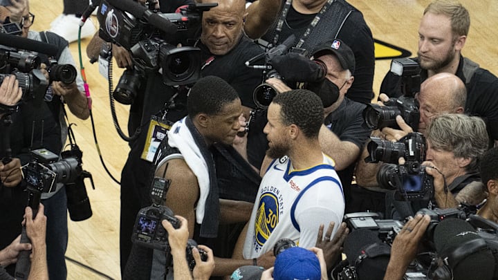 April 30, 2023; Sacramento, California, USA; Golden State Warriors guard Stephen Curry (30) hugs Sacramento Kings guard De'Aaron Fox (5) after game seven of the 2023 NBA playoffs first round at Golden 1 Center. Mandatory Credit: Kyle Terada-Imagn Images