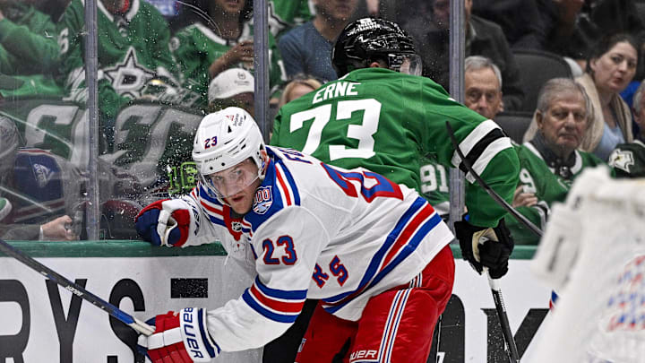 Apr 11, 2026; Dallas, Texas, USA; New York Rangers defenseman Adam Fox (23) checks Dallas Stars left wing Adam Erne (73) during the second period at the American Airlines Center. 