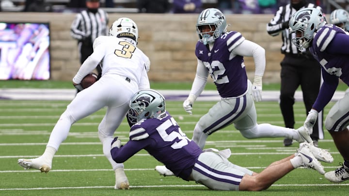 Nov 29, 2025; Manhattan, Kansas, USA; Colorado Buffaloes quarterback Kaidon Salter (3) is tackled by Kansas State Wildcats defensive end Ryan Davis (52), linebacker Desmond Purnell (32) and defensive tackle Malcolm Alcorn-Crowder (55) during the fourth quarter at Bill Snyder Family Football Stadium. Mandatory Credit: Scott Sewell-Imagn Images