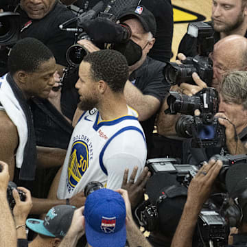 April 30, 2023; Sacramento, California, USA; Golden State Warriors guard Stephen Curry (30) hugs Sacramento Kings guard De'Aaron Fox (5) after game seven of the 2023 NBA playoffs first round at Golden 1 Center. Mandatory Credit: Kyle Terada-Imagn Images