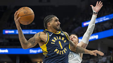 Mar 17, 2025; Minneapolis, Minnesota, USA; Indiana Pacers forward Obi Toppin (1) drives to the basket past Minnesota Timberwolves guard Donte DiVincenzo (0) in the second half at Target Center. Mandatory Credit: Jesse Johnson-Imagn Images