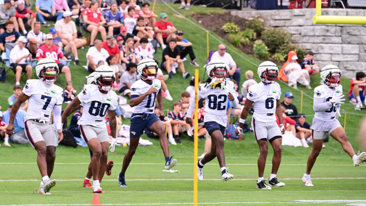 Jul 24, 2024; Foxborough, MA, USA; New England Patriots wide receiver JuJu Smith-Schuster (7), wide receiver Kayshon Boutte (80), wide receiver Tyquan Thornton (11), wide receiver JaQuae Jackson (82), wide receiver Javon Baker (6), and wide receiver Kawaan Baker (86) work on drills during training camp at Gillette Stadium. Mandatory Credit: Eric Canha-USA TODAY Sports