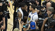April 30, 2023; Sacramento, California, USA; Golden State Warriors guard Stephen Curry (30) hugs Sacramento Kings guard De'Aaron Fox (5) after game seven of the 2023 NBA playoffs first round at Golden 1 Center. Mandatory Credit: Kyle Terada-Imagn Images