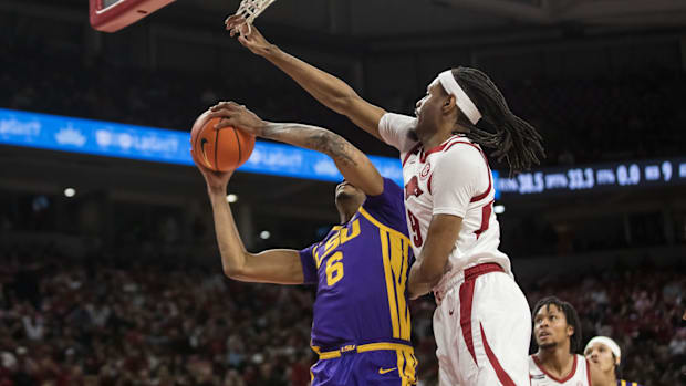 Jonas Aidoo (9) goes up to block a shot by LSU Tigers forward Robert Miller III (6) during the first half at Bud Walton Arena