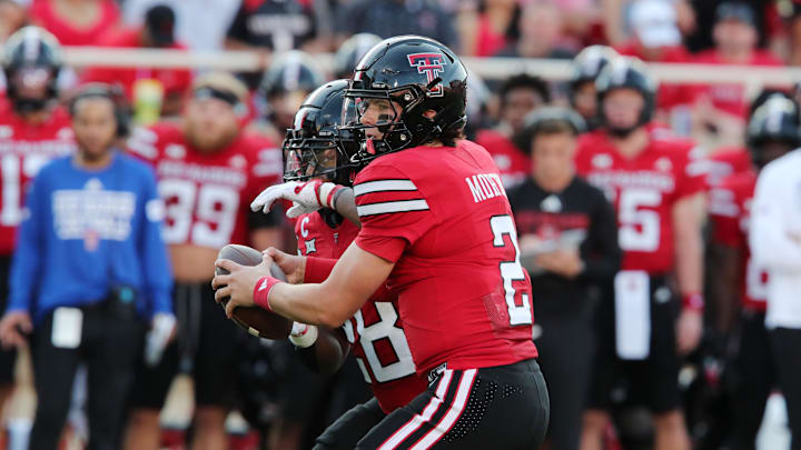 Aug 31, 2024; Lubbock, Texas, USA;  Texas Tech Red Raiders quarterback Behren Morton (2) hands the ball to running back Tahj Brooks (28) in the first half during the game against the Abilene Christian Wildcats at Jones AT&T Stadium and Cody Campbell Field. Mandatory Credit: Michael C. Johnson-Imagn Images