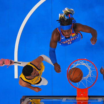 Jun 8, 2025; Oklahoma City, Oklahoma, USA;  Indiana Pacers guard Tyrese Haliburton (left) and forward Pascal Siakam (right) watch the ball go into the basket against Oklahoma City Thunder guard Luguentz Dort (5) and forward Jalen Williams (8) during the first half during game two of the 2025 NBA Finals at Paycom Center. Mandatory Credit: Kyle Terada-Imagn Images