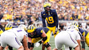 Michigan quarterback Bryce Underwood (19) talks to teammates before a play against Washington during the second half at Michigan Stadium in Ann Arbor on Saturday, Oct. 18, 2025.