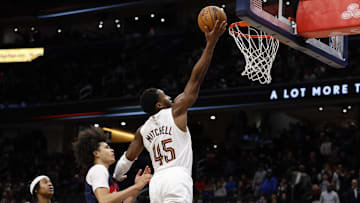 Dec 12, 2025; Washington, District of Columbia, USA; Cleveland Cavaliers guard Donovan Mitchell (45) shoots the ball as Washington Wizards forward Kyshawn George (18) chases in the fourth quarter at Capital One Arena. Mandatory Credit: Geoff Burke-Imagn Images