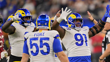 Nov 23, 2025; Inglewood, California, USA; Los Angeles Rams defensive end Kobie Turner (91) celebrates with linebacker Jared Verse (8) and defensive end Braden Fiske (55) after sacking quarterback Baker Mayfield (not pictured) during the second quarter at SoFi Stadium. Mandatory Credit: Jayne Kamin-Oncea-Imagn Images