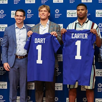 Apr 25, 2025; East Rutherford, NJ, US; New York Giants president John Mara (far left), general manager Joe Schoen (left), Jaxson Dart, Abdul Carter, and head coach Brian Daboll (right) pose for photos prior to the start of the press conference to introduce the Giants first round draft picks.  Mandatory Credit: Thomas Salus-Imagn Images
