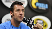 Jul 19, 2015; Loudon, NH, USA; Movie actor Adam Sandler speaks to the media before the 5-Hour Energy 301 at New Hampshire Motor Speedway. Mandatory Credit: Jasen Vinlove-Imagn Images