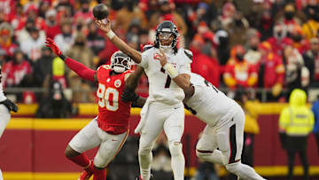 Jan 18, 2025; Kansas City, Missouri, USA; Houston Texans quarterback C.J. Stroud (7) throws a pass against Kansas City Chiefs defensive end Charles Omenihu (90) during the third quarter of a 2025 AFC divisional round game at GEHA Field at Arrowhead Stadium. Mandatory Credit: Jay Biggerstaff-Imagn Images