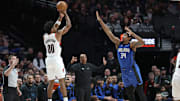 Jan 30, 2025; Portland, Oregon, USA: Portland Trail Blazers guard Scoot Henderson (00) shoots the ball over Orlando Magic center Wendell Carter Jr. (34) in the second half at Moda Center. Mandatory Credit: Jaime Valdez-Imagn Images