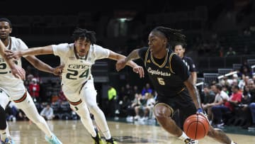 Dec 16, 2023; Coral Gables, Florida, USA; La Salle Explorers guard Khalil Brantley (5) drives to the basket past Miami Hurricanes guard Nijel Pack (24) during the first half at Watsco Center. Mandatory Credit: Sam Navarro-USA TODAY Sports