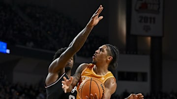 Feb 22, 2025; College Station, Texas, USA; Tennessee Volunteers guard Zakai Zeigler (5) shoots the ball as Texas A&M Aggies forward Solomon Washington (9) defends during the second half at Reed Arena. Mandatory Credit: Maria Lysaker-Imagn Images 