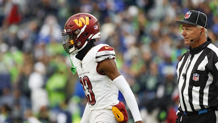 Nov 12, 2023; Seattle, Washington, USA; Washington Commanders cornerback Emmanuel Forbes (13) reacts after being ejected for a personal foul during the first quarter at Lumen Field. Mandatory Credit: Joe Nicholson-Imagn Images