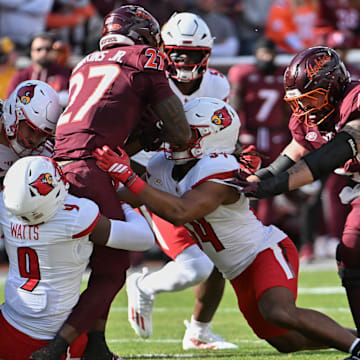 Nov 1, 2025; Blacksburg, Va.; Louisville defensive back Antonio Watts (9) tackles Virginia Tech running back Marcellous Hawkins (27).