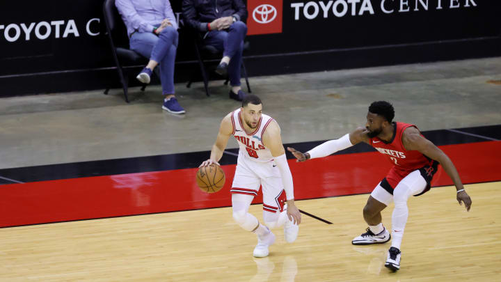 Feb 22, 2021; Houston, Texas, USA; Zach LaVine #8 of the Chicago Bulls controls the ball ahead of David Nwaba #2 of the Houston Rockets during the second quarter at Toyota Center. 