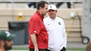 Oct 18, 2025; Bloomington, Indiana, USA; Indiana Hoosiers head coach Curt Cignetti and Michigan State Spartans head coach Jonathan Smith talk prior to the game at Memorial Stadium. Mandatory Credit: Robert Goddin-Imagn Images