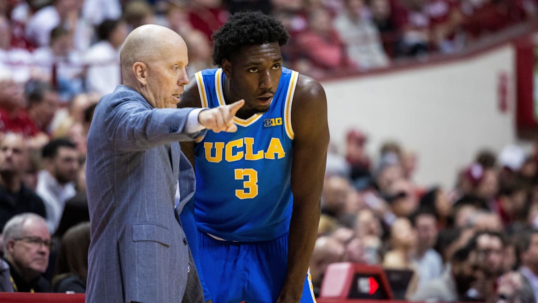 UCLA Bruins head coach Mick Cronin talks to guard Eric Dailey Jr. (3)