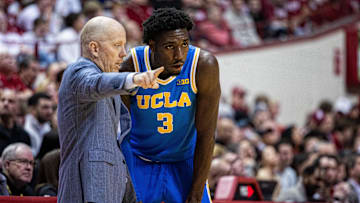 UCLA Bruins head coach Mick Cronin talks to guard Eric Dailey Jr. (3)
