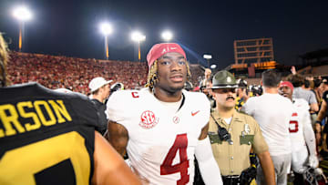 Oct 5, 2024; Nashville, Tennessee, USA;  Alabama Crimson Tide quarterback Jalen Milroe (4) shakes hands with Vanderbilt Commodores wide receiver Micah Bell (26) after a game at FirstBank Stadium. Mandatory Credit: Steve Roberts-Imagn Images